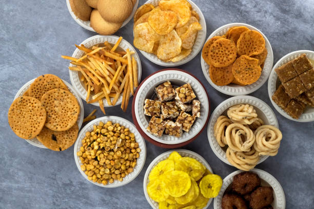 istock Selective focused Treditional Indian Diwali salty snacks and foods items and empty lamp on an isolated background. Tamilnadu snacks for the Diwali festival. 1342388845