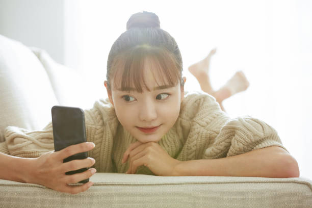 istock A young Asian woman operating a phone at home 1342388899