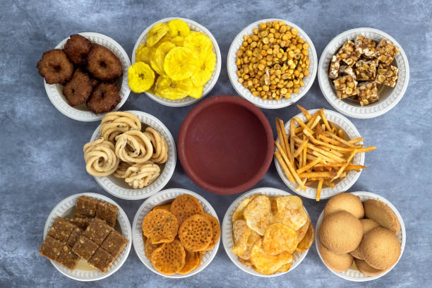 istock Selective focused Treditional Indian Diwali salty snacks and foods items and empty lamp on an isolated background. Tamilnadu snacks for the Diwali festival. 1342388966