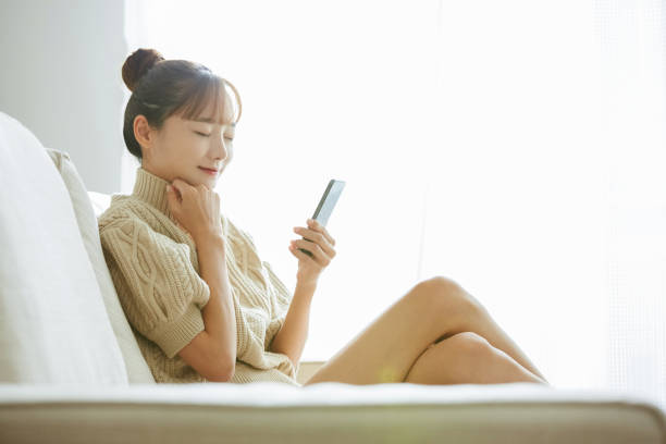 istock A young Asian woman operating a phone at home 1342389005