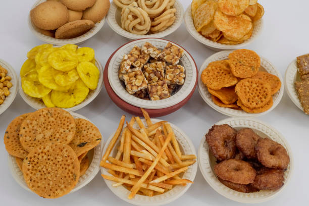 istock Selective focused Treditional Indian Diwali salty snacks and foods items and empty lamp on an isolated background. Tamilnadu snacks for the Diwali festival. 1342389523