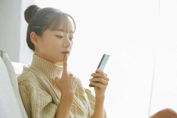 istock A young Asian woman operating a phone at home 1342389546