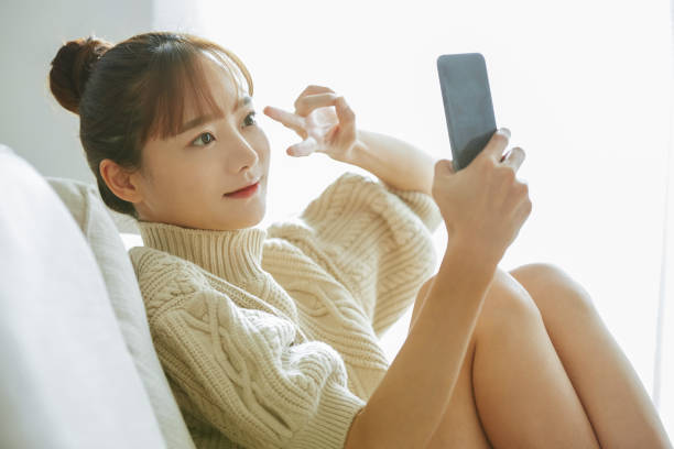 istock A young Asian woman operating a phone at home 1342389549
