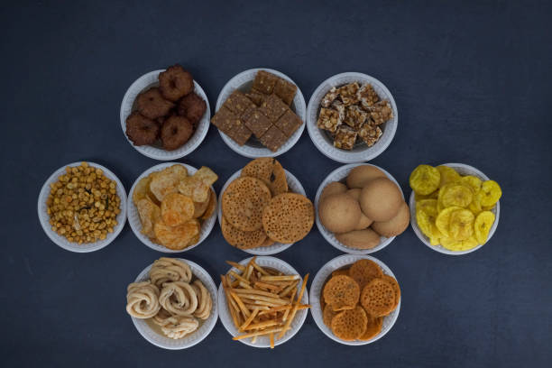 istock Selective focused Treditional Indian Diwali salty snacks and foods items and empty lamp on an isolated background. Tamilnadu snacks for the Diwali festival. 1342389958