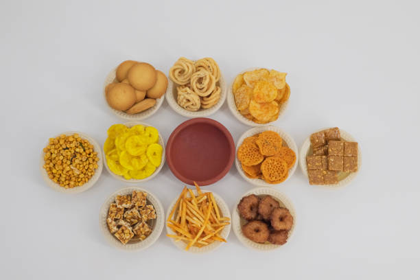 istock Selective focused Treditional Indian Diwali salty snacks and foods items and empty lamp on an isolated background. Tamilnadu snacks for the Diwali festival. 1342390521