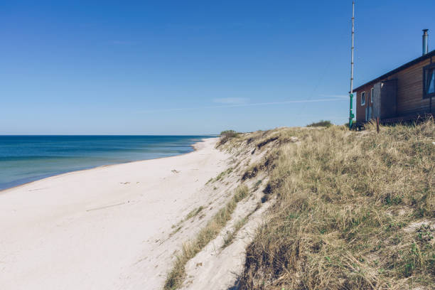 istock small building and white sand beach and Baltic sea view at curonian spit 1342390881
