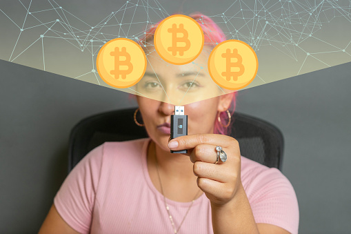 young woman showing wallet for cryptocurrency storage, with hologram full of bitcoin and connections. finance and technology