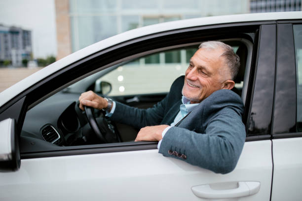 istock Successful senior man wearing business suit driving a car 1342393607