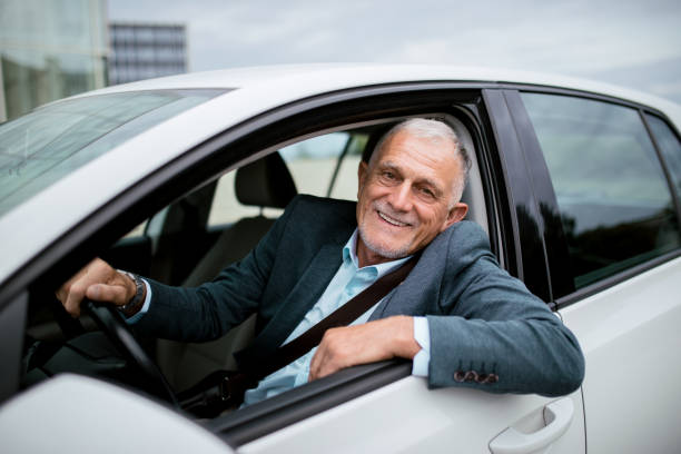 istock Successful man wearing business suit driving a car 1342393610