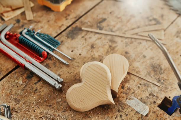 istock Two decorative wooden heart shapes on a carpentry workbench 1342397338