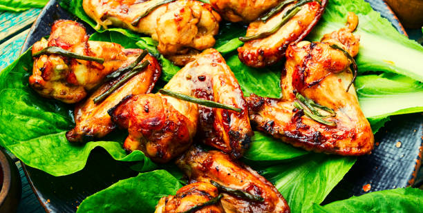istock Grilled chicken wings on lettuce leaves 1342397424