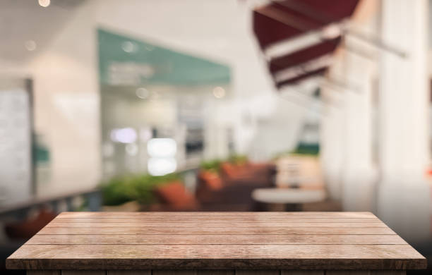 istock Empty wooden table top with lights bokeh on blur restaurant background 1342399588