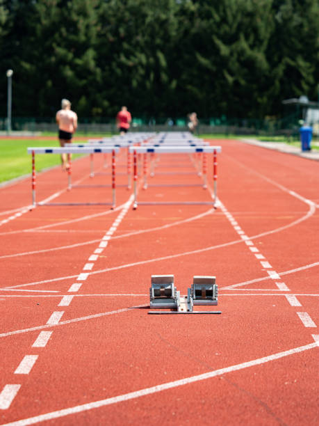 istock Obstacle Course Training. Athletics Starting Blocks And Red Running Tracks In A Stadion 1342402053
