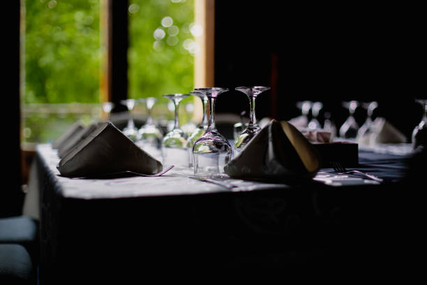 istock Shallow depth of field (selective focus) image with a restaurant table ready to receive customers. Empty glasses and tableware. 1342404326
