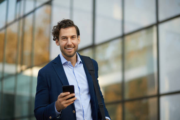istock Young businessman typing text message on his way to work 1342404393
