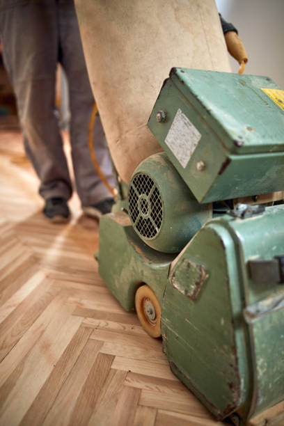 istock Repairman restoring parquet with a sanding machine. 1342405078