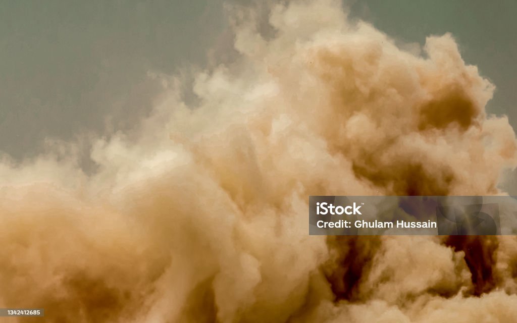 Dust storm in the desert Dust clouds and flying rock particles during detonator blast on the construction site in the middle east Sandstorm Stock Photo