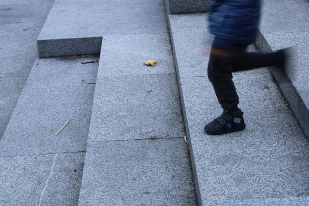 istock Boy is walking down the stairs 1342414217