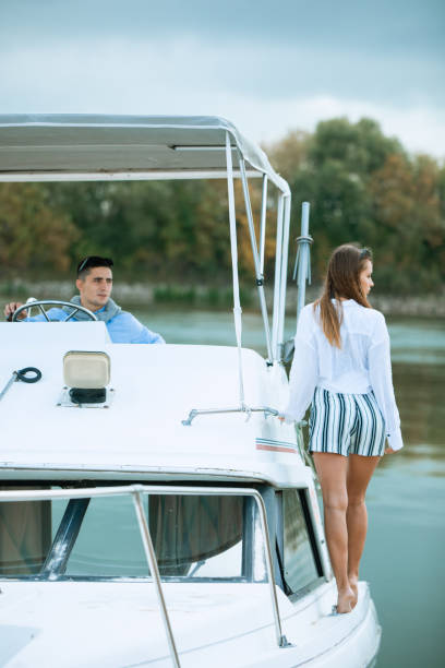 Beautiful couple resting on the yacht. Yachting. Luxury lifestyle. Luxurious life for woman enjoying travel, summer vacation. Taking an adventurous boat cruise stock photo