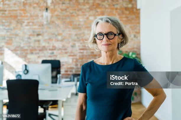 Portrait Of A Senior Businesswoman Standing In Office Stock Photo - Download Image Now
