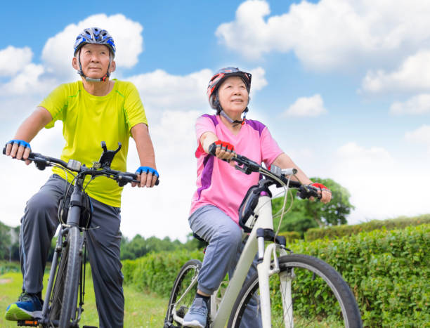 istock Happy  senior couple exercising with bicycles 1342418973