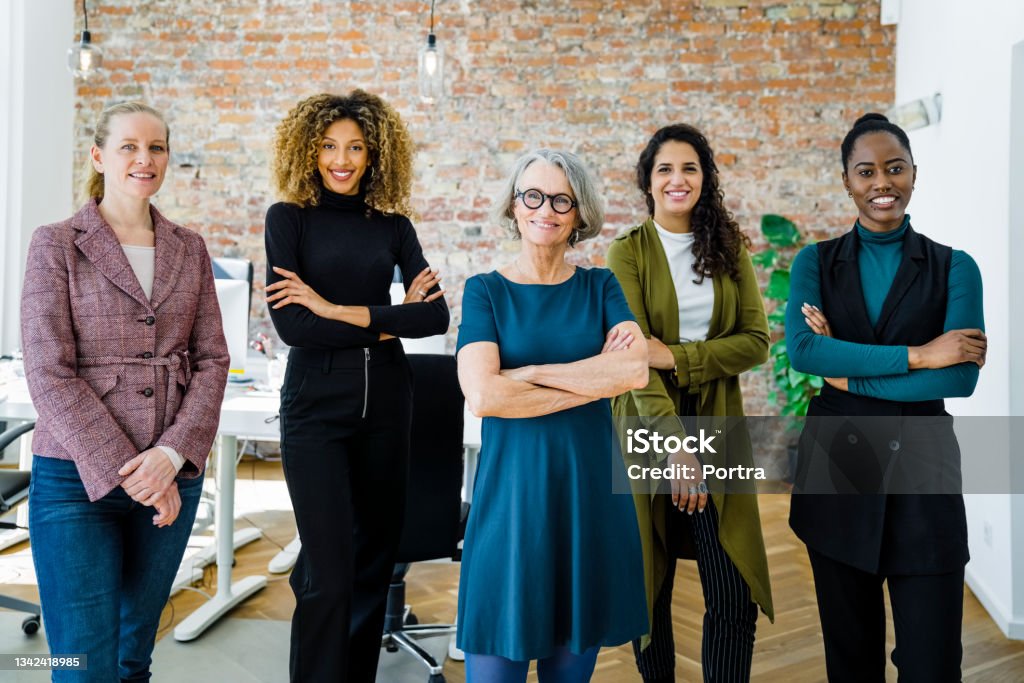 Portrait of successful female business team in office Portrait of successful female business team in office. Multiracial business group standing together and looking at camera. Women Stock Photo