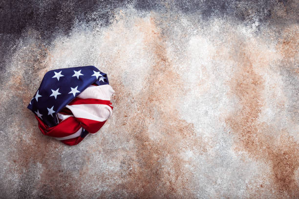 istock American rolled flag on grunge background 1342420279