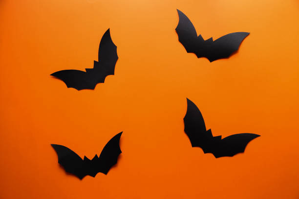 istock Bats on an orange background. Happy Halloween 1342421487