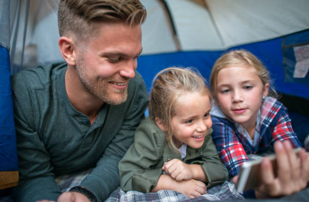 istock Watching Videos in the Tent with Dad 1342425908