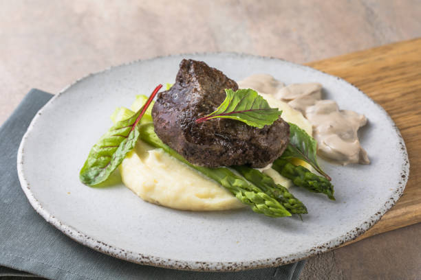 Traditional steak and mashed potatoes with blanched asparagus