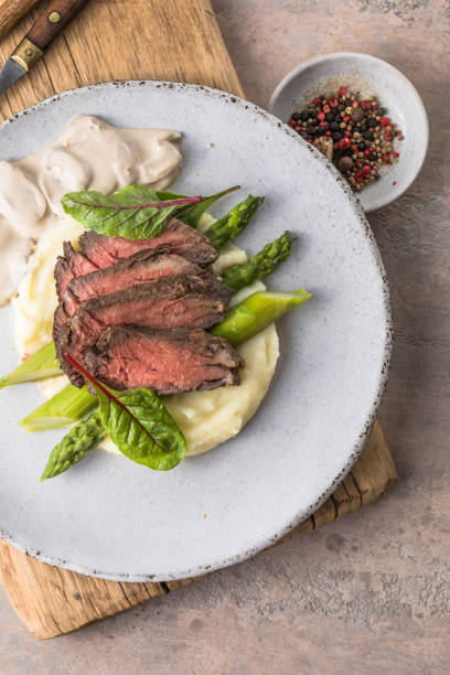 Traditional steak and mashed potatoes with blanched asparagus