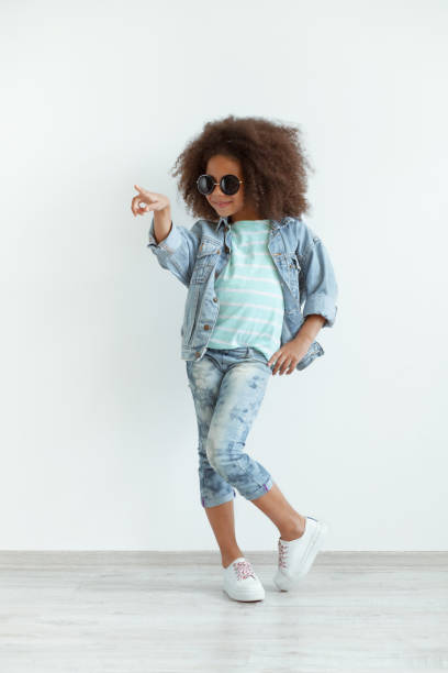 beautiful stylish little girl in denim clothes - cool glasses sunglasses fashion imagens e fotografias de stock