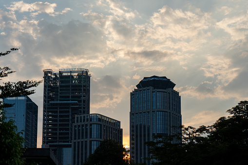 After the sunset, silhouettes of city buildings under construction