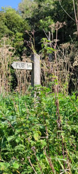 istock Wooden signpost, Pub 1 mile. 1342432819