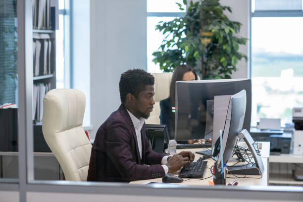 istock Young serious African businessman looking at computer screen 1342438490