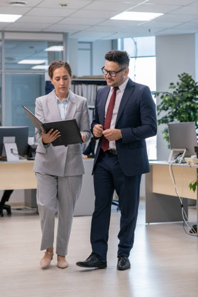 istock Confident businessman and his secretary discussing documents 1342438498