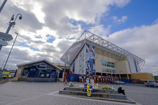 Leeds, United Kingdom - August 17, 2021: Exterior view of Elland Road football stadium with the Billy Bremner statue in the foreground in Leeds, England