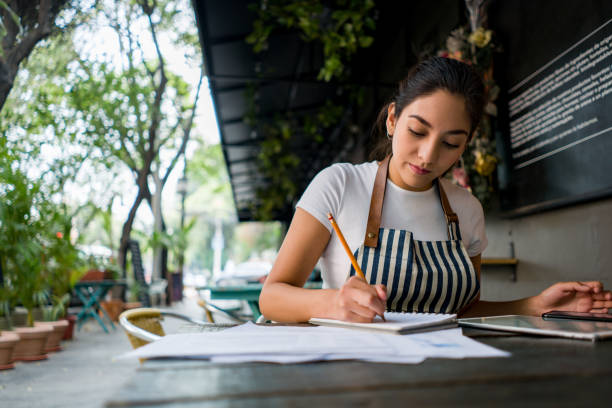 istock Business owner working at a restaurant doing the books 1342439507