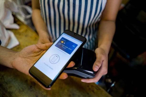 istock Close-up on a customer at a grocery store making a contactless payment 1342439517
