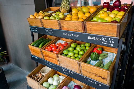 Market stall with fresh fruits and vegetables at a local supermarket - grocery shop concepts