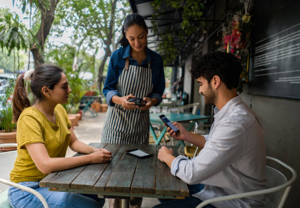 istock Man paying with his cell phone at a restaurant 1342439566