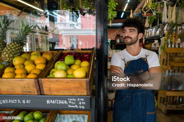 Man Working At A Local Supermarket And Waiting For Clients Stock Photo - Download Image Now