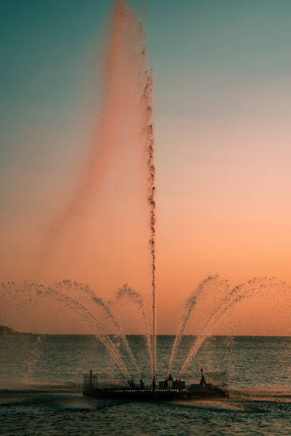 istock Fountain in the sea. Beautiful sunset. 1342441712