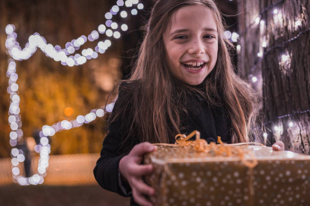 istock Girl carrying gift boy and smiling 1342443809