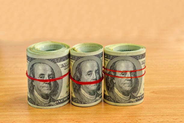 istock US hundred dollar bills on wooden table, selective focus. 1342444650