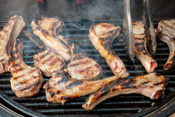 istock Lamb cutlets chops grilling on barbecue plate . Backyard BBQ grill cooking. Australia Day celebration 1342446622