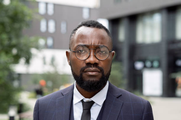 Young serious businessman in eyeglasses and suit