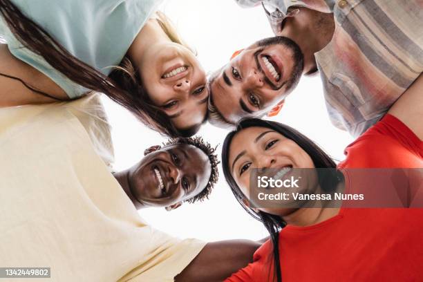 Group Of Diverse Friends Hugging In Circle Happy People Having Fun Outdoor Main Focus In Gay Man Face Stock Photo - Download Image Now