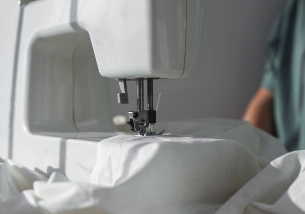 istock White cotton cloth on sewing machine close up 1342450675