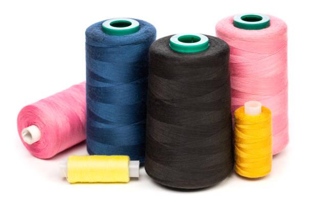 istock Sewing thread spools of various colors isolated on white background 1342450887